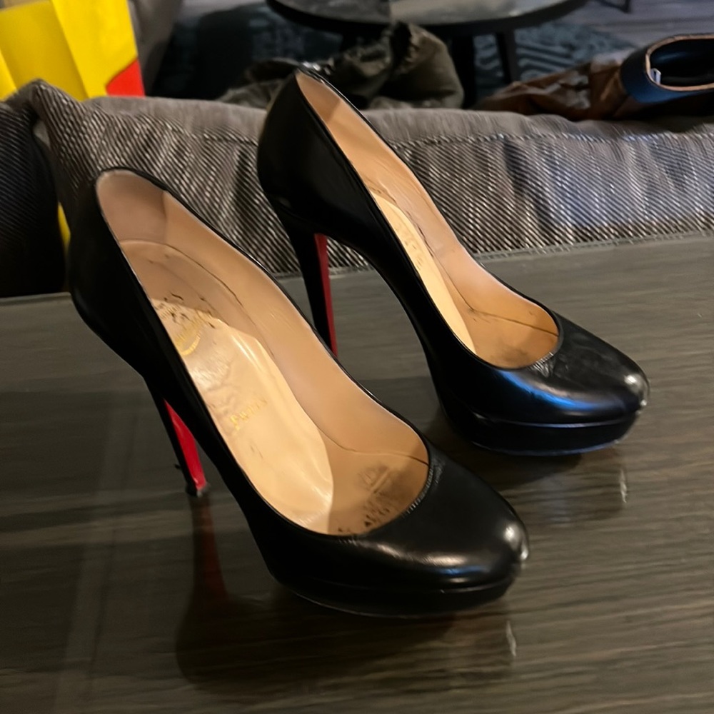Black Louboutin heels.